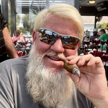 John Daly posed for a picture with a cigar in his hand